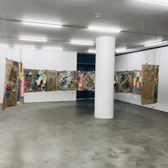 Installation view. <i>Modern Untitled Tragic Timeline</i>, 2019. Collage: acrylic paint, cash, grocery bags on paper, acrylic tubes and twine. 45 x 720 in./ 114.3 x 1828.8 cm.